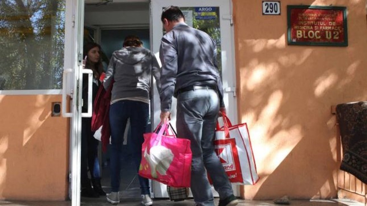 Studenți care intră în cămin