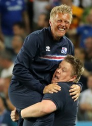 epa05395444 Iceland's coach Heimir Hallgrimsson (L) reacts at the end of the UEFA EURO 2016 round of 16 match between England and Iceland at Stade de Nice in Nice, France, 27 June 2016. Iceland won the match 2-1. (RESTRICTIONS APPLY: For editorial news reporting purposes only. Not used for commercial or marketing purposes without prior written approval of UEFA. Images must appear as still images and must not emulate match action video footage. Photographs published in online publications (whether via the Internet or otherwise) shall have an interval of at least 20 seconds between the posting.) EPA/OLIVER WEIKEN EDITORIAL USE ONLY
