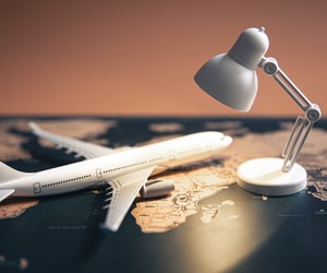 A small table lamp and a plane on a world map.
