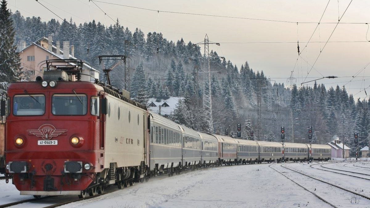 CFR Călători modernizează 90 de vagoane. Tren CFR, pe timo de iarnă, cu zăpadă între linii