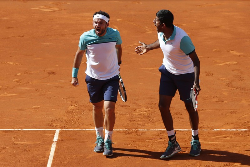 epa04742024 Indian tennis player Rohan Bopanna (R) and Romanian Florin Mergea (L) celebrate after defeating Polish Marcin Matkowski and Serbian Nenad Zimonjic in the Mutua Madrid Tennis Open tournament's double final match in Madrid, Spain, 10 May 2015. Bopanna and Mergea won by 6-2, 6-7 (5) and 11-9. EPA/Juan Carlos Hidalgo
