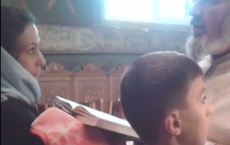 Imagini incredibile la un botez. Preotul se enervează pe o enoriaşă şi o ceartă în biserică | VIDEO