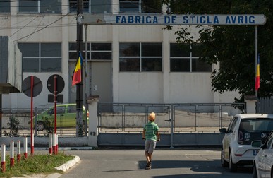 Copil, la joacă în fața porții pe care ieșeau odată peste 1.200 de muncitori