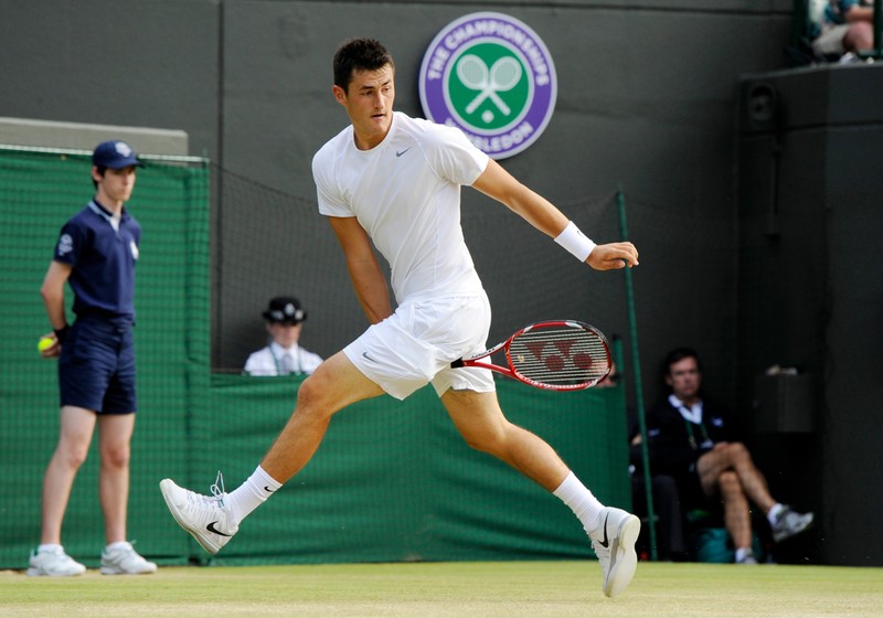 epa03770058 Bernanrd Tomic of Australia returns to Tomas Berdych of the Czech Republic during their fourth round match for the Wimbledon Championships at the All England Lawn Tennis Club, in London, Britain, 01 July 2013. EPA/GERRY PENNY EDITORIAL USE ONLY/NO COMMERCIAL SALES