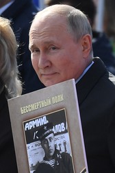 Russian President Vladimir Putin carries a portrait of his father Vladimir Spiridonovich as he takes part in the Immortal Regiment march on Red Square in central Moscow on May 9, 2022. Russia celebrates the 77th anniversary of the victory over Nazi Germany during World War II.,Image: 689812635, License: Rights-managed, Restrictions: , Model Release: no