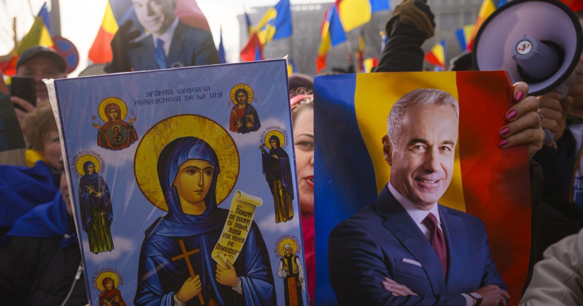 O femeie ține în mâini o fotografie a lui Călin Georgescu și o icoană, în timpul unui protest împotriva anulării alegerilor prezidențiale, în fața sediului Curții Constițuionale a României, în Bucuresti, vineri, 10 ianuarie 2025.