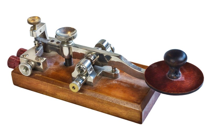 Ancient morse code telegraphy device isolated on a white background