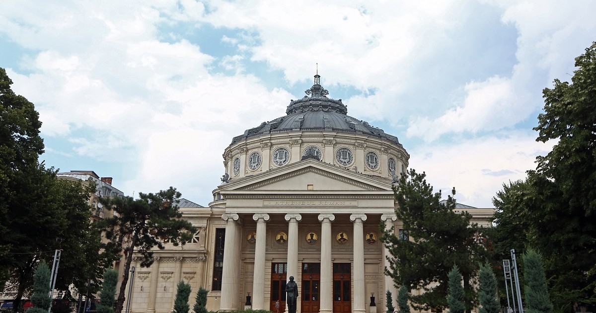 Măsurile luate de MAI pentru mitingul de la Ateneu. Ministrul de Interne, Carmen Dan, zâmbind, îmbrăcată în albastru, cu mâinile, una peste alta, pe birou. Ateneul Român