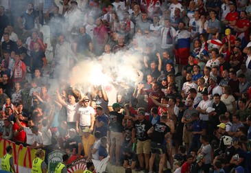 epa05358405 Russian fans light flares during the UEFA EURO 2016 group B preliminary round match between England and Russia at Stade Velodrome in Marseille, France, 11 June 2016. The match ended 1-1. (RESTRICTIONS APPLY: For editorial news reporting purposes only. Not used for commercial or marketing purposes without prior written approval of UEFA. Images must appear as still images and must not emulate match action video footage. Photographs published in online publications (whether via the Internet or otherwise) shall have an interval of at least 20 seconds between the posting.) EPA/ALI HAIDER EDITORIAL USE ONLY