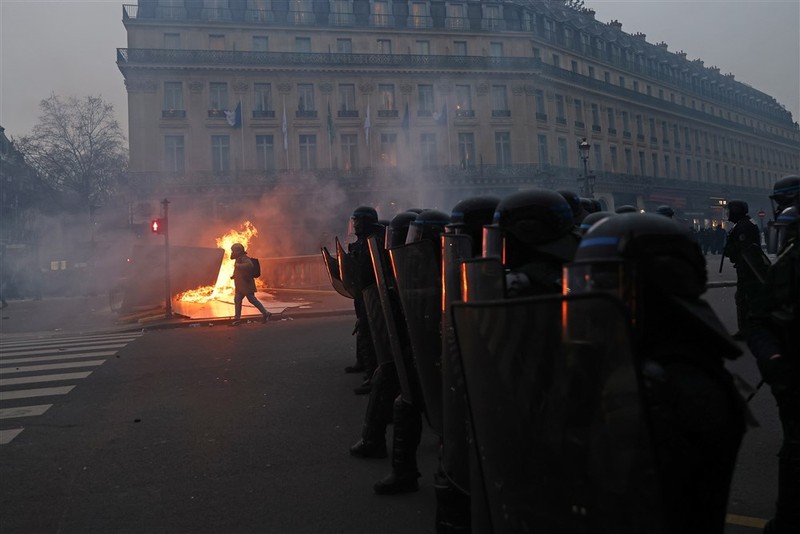 epa10539234 French anti-riot police secure their position at ‘Place de l’Opera’ during clashes with protesters as thousands of people participate in a protest against the government's reform of the pension system in Paris, France, 23 March 2023. Protests continue in France after the prime minister announced on 16 March 2023 the use of Article 49 paragraph 3 (49.3) of the French Constitution to have the text on the controversial pension reform law - raising retirement age from 62 to 64 - be definitively adopted without a vote. EPA-EFE/MOHAMMED BADRA