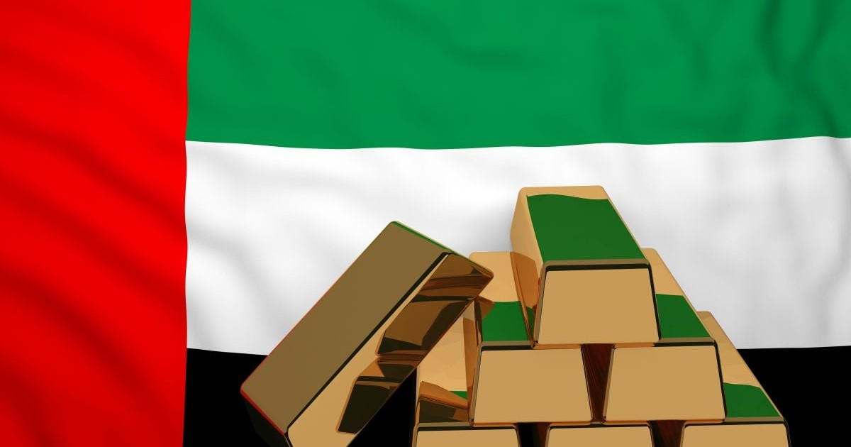Șase lingouri de aur au pe fundal steagul Emiratelor Arabe Unite