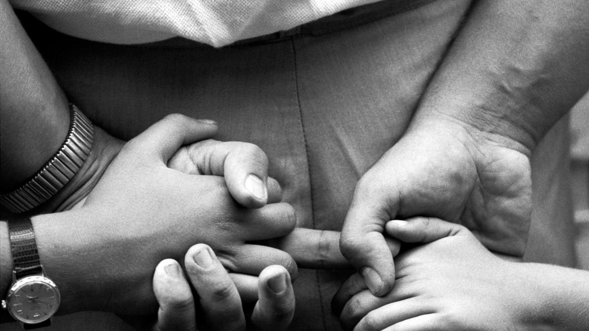 Father holding his children's hands