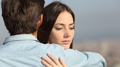 Sad woman hugging her boyfriend couple problems