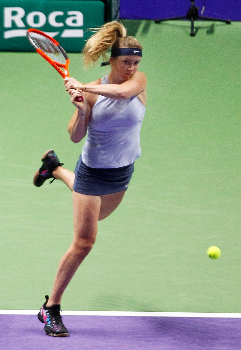 epa06284301 Elina Svitolina of Ukraine in action against Caroline Wozniacki of Denmark during their round robin match of the BNP Paribas WTA Tour Finals 2017 tennis tournament at the Indoor Stadium in Singapore, 23 October 2017. EPA-EFE/WALLACE WOON
