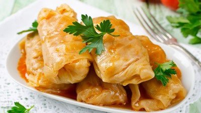 Stuffed cabbage rolls with rice and meat in tomato sauce