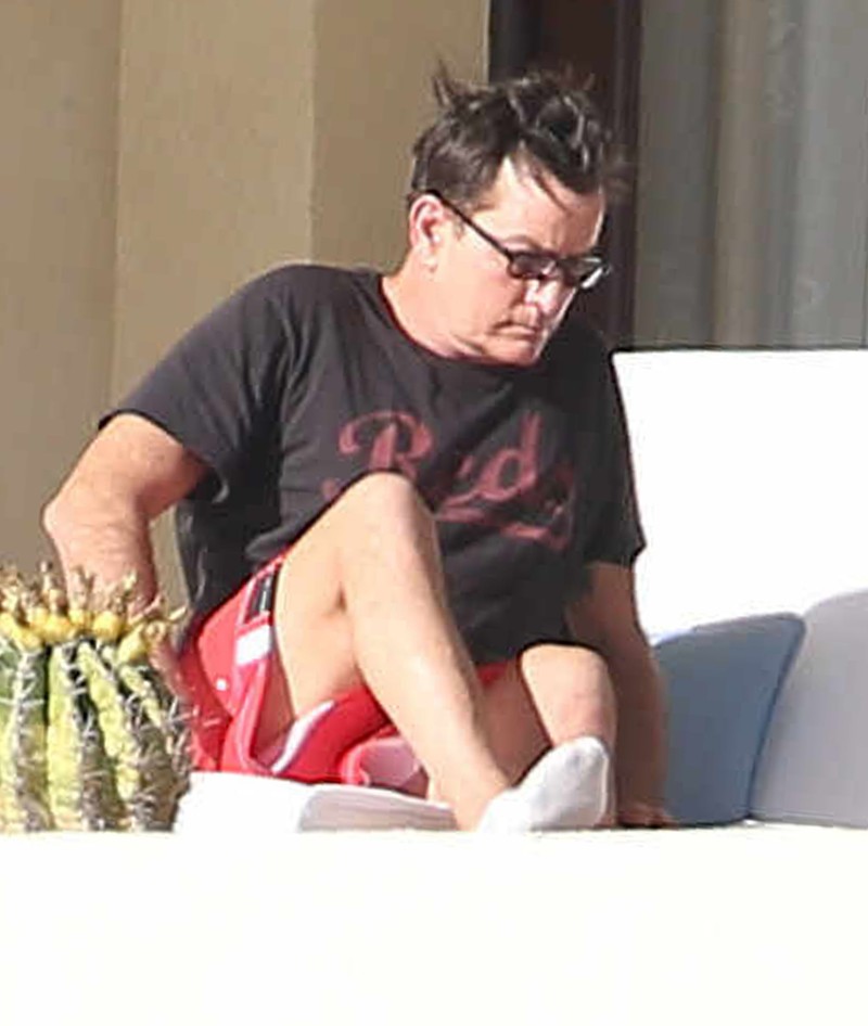 Exclusive... 51952775 Actor Charlie Sheen is seen relaxing on his balcony while vacationing in Cabo San Lucas, Mexico on January 21, 2016. Charlie is having a tough time lately, first it was his HIV positive admission and now his ex-wife Denise Richards is suing him, claiming that he is taking money out of their daughters trust funds that he made for them. ***NO WEB USE W/O PRIOR AGREEMENT - CALL FOR PRICING*** FameFlynet, Inc - Beverly Hills, CA, USA - +1 (310) 505-9876