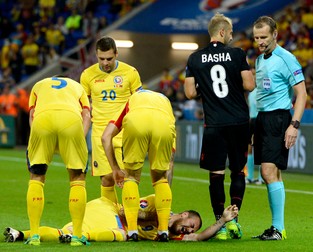 epa05378136 Denis Alibec (down) of Romania reacts in pain during the UEFA EURO 2016 group A preliminary round match between Romania and Albania at Stade de Lyon in Lyon, France, 19 June 2016. (RESTRICTIONS APPLY: For editorial news reporting purposes only. Not used for commercial or marketing purposes without prior written approval of UEFA. Images must appear as still images and must not emulate match action video footage. Photographs published in online publications (whether via the Internet or otherwise) shall have an interval of at least 20 seconds between the posting.) EPA/ROBERT GHEMENT EDITORIAL USE ONLY