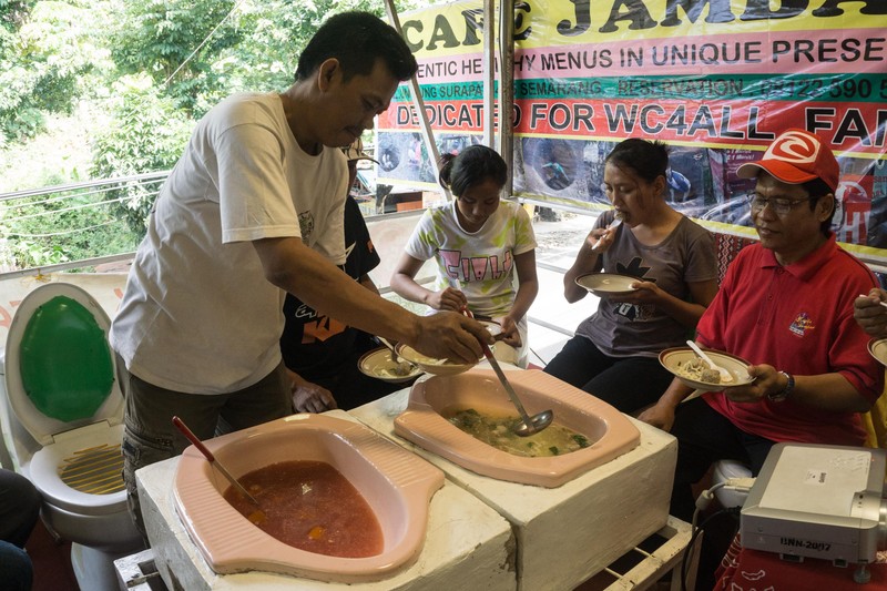SEMARANG, INDONESIA - JULY 01: Visitors enjoy food served in the toilet, in the Jamban cafe on July 01, 2016 in Semarang, Indonesia. The food at this Jamban cafe is served on a squat toilet as a container. The cafe chairs are made as of toilet sitting. Cafe that has existed since two months is intentionally designed as a campaign concerning about sanitation, which is still a major problem in Indonesia. PHOTOGRAPH BY Dhana Kencana / Barcroft Images London-T:+44 207 033 1031 E:hello@barcroftmedia.com - New York-T:+1 212 796 2458 E:hello@barcroftusa.com - New Delhi-T:+91 11 4053 2429 E:hello@barcroftindia.com www.barcroftmedia.com *** Local Caption *** 02543795