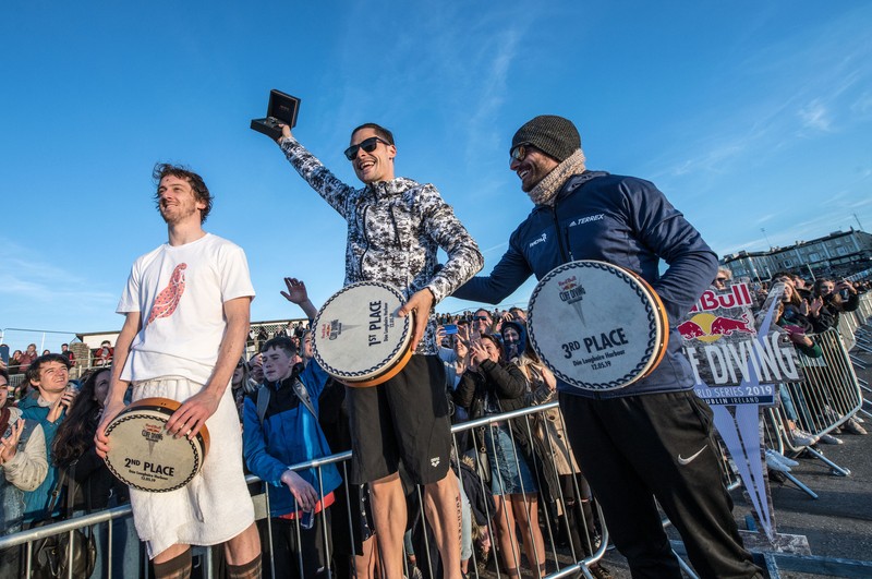 Gary Hunt of the UK, Constantin Popovici of Romania and David Colturi of the USA celebrate on the podium at Dun Laoghaire Harbour after the second stop of the Red Bull Cliff Diving World Series in Dublin, Ireland on May 12, 2019.