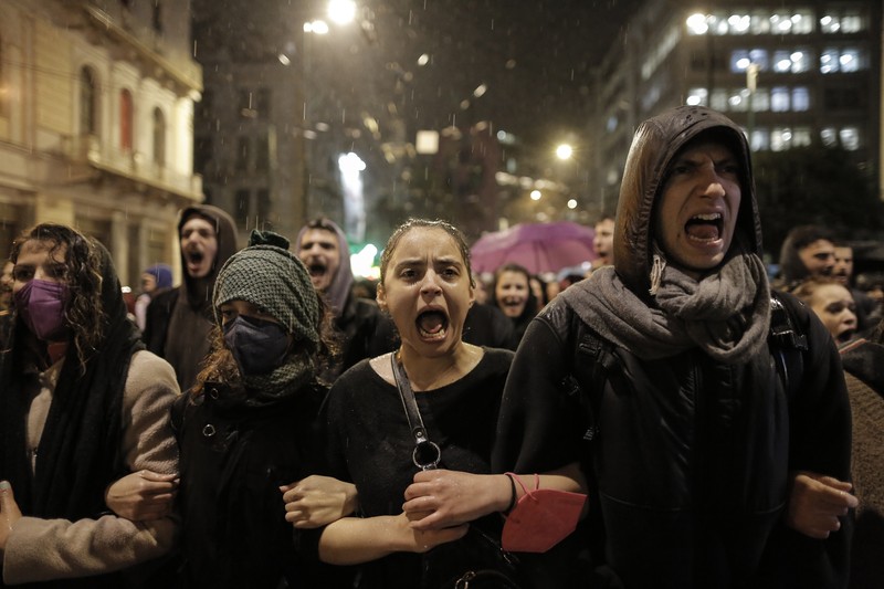 epaselect epa10499340 Youths shout slogans during a protest march in Athens, Greece, 2 March 2023, over the deadly train crash in central Greece. The death toll of the train collision that occurred on the Athens-Thessaloniki line has risen to 57, Hellenic Police spokesperson confirmed 02 March evening, while 48 people are still in hospital. The collision occurred late on Tuesday 28 February night near Tempi in central Greece between a passenger train travelling north and a freight train travelling south on the same line. A station master in the central Greek city of Larissa has been detained over the accident. EPA-EFE/KOSTAS TSIRONIS