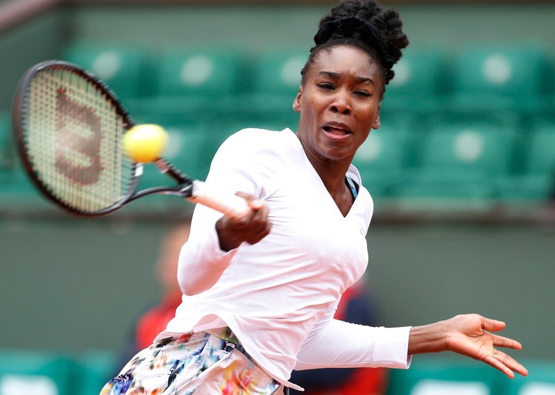 epa04229450 Venus Williams of USA returns to Anna Schmiedlova of Slovakia during their second round match for the French Open tennis tournament at Roland Garros in Paris, France, 28 May 2014. EPA/IAN LANGSDON