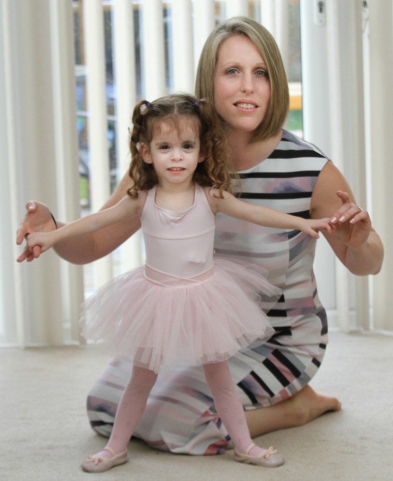 *** UK OUT *** *** EXCLUSIVE *** SANDHURST, UNITED KINGDOM - UNDATED: Three year old Rebecca Lewendon with mum Lynne pictured at home in Sandhurst, Berkshire, England. STANDING at only 80 centimetres tall, tiny Rebecca Lewendon could be forgiven for taking a back seat. But the pint sized Thumbelina is determined that her tiny stature wont set her back. Her parents were baffled when she failed to grow when she was born. But she has been diagnosed with a rare growth condition that means at the age of three, she is still only the height of a 12 month old baby. But she is determined to live a normal life - and to join in ballet classes with her sister Kimberley, seven, and brother Ryan, five. PHOTOGRAPH BY Worldwide Features / Barcroft Media UK Office, London. T +44 845 370 2233 W www.barcroftmedia.com USA Office, New York City. T +1 212 796 2458 W www.barcroftusa.com Indian Office, Delhi. T +91 11 4053 2429 W www.barcroftindia.com *** Local Caption *** 02455787