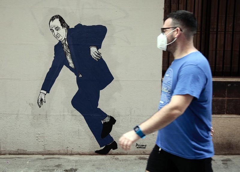 Un graffiti realizat pe un zid din Valencia de un artist auto-intitulat Vărul lui Bansky, cu regele Juan Carlos fugind. Foto: EPA