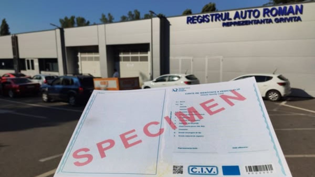 specimen al unei cărți de identitate a unui vehicul, ținută în mână de o persoană, în fața unei reprezentațe a Registrului Auto Român