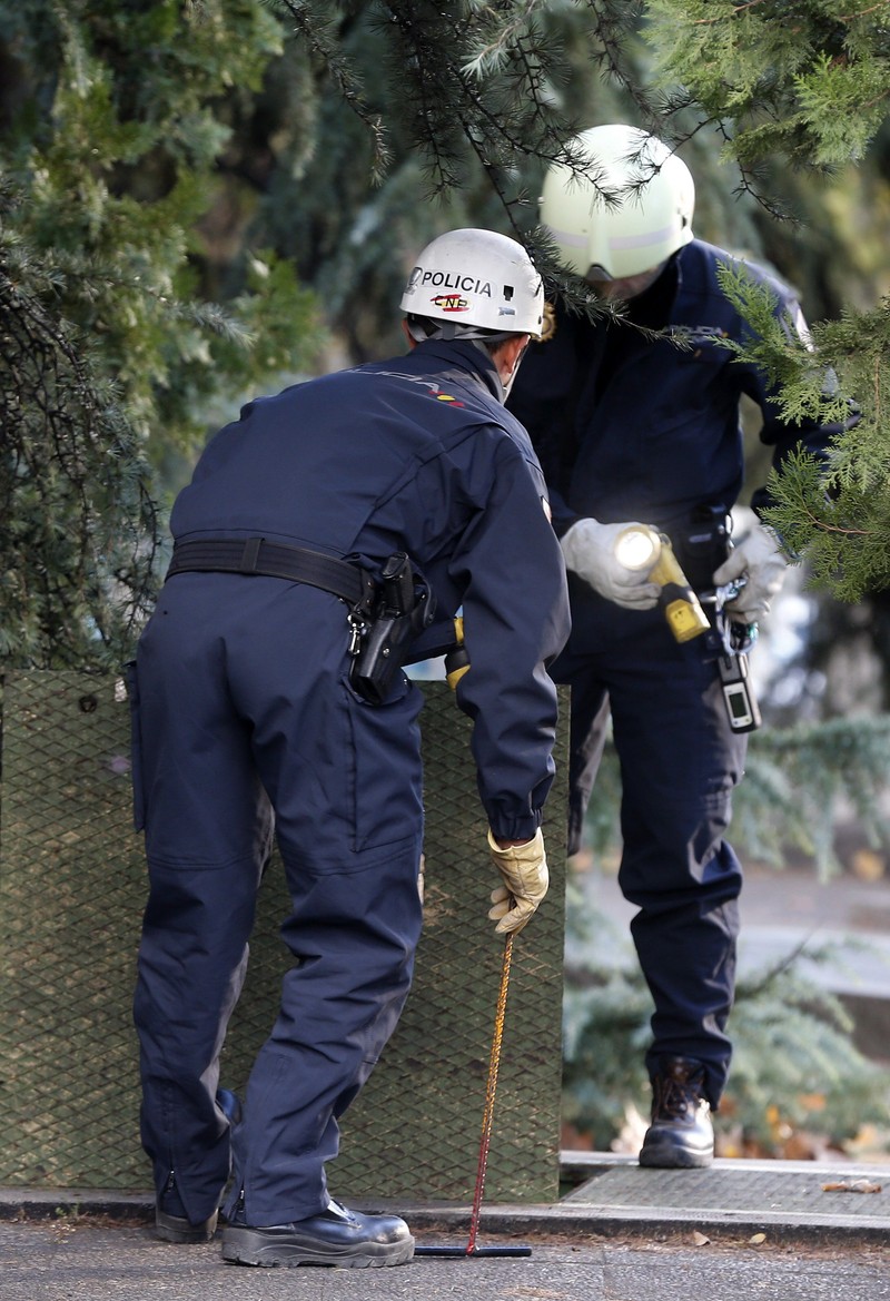 epa05035410 Two policemen search the drains in surroundings of Santiago Bernabeu Stadium in Madrid, Spain, several hours before the starting of 'El Clasico' match between Real Madrid and FC Barcelona, 21 November 2015. Exceptional tight security measures are taken for the match after the 13 November recent terrorist attacks in Paris. A total of 1,200 policemen, six times more than the policemen deployed in a similar game, 120 local policemen and 1,195 Real Madrid's private security guards, will look after 80,000 supporters who will attend the Primera Division league match. EPA/CHEMA MOYA