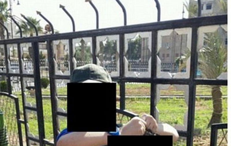 IMAGINE ŞOCANTĂ! Un copil de 7 ani SE CHINUIE să ţină ÎN MÂINI CAPUL UNUI SIRIAN OMORÂT DE TATĂL SĂU