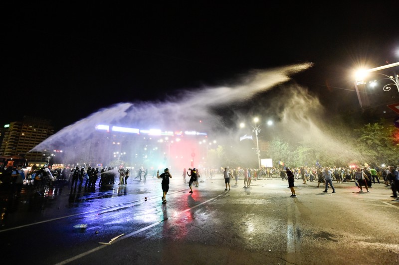 Trupele de jandarmi evacuând protestatarii din Piața Victoriei cu tunuri de apă și gaze lacrimogene | Foto: Agerpres