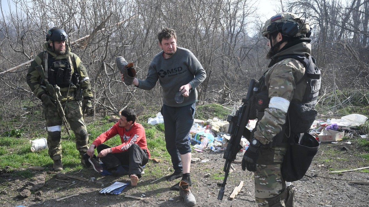 Soldați percheziționând ccivili în Mariupol | Foto: Profimedia