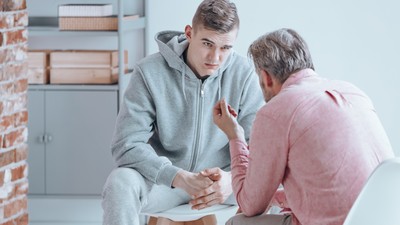 Teenager talking with counselor