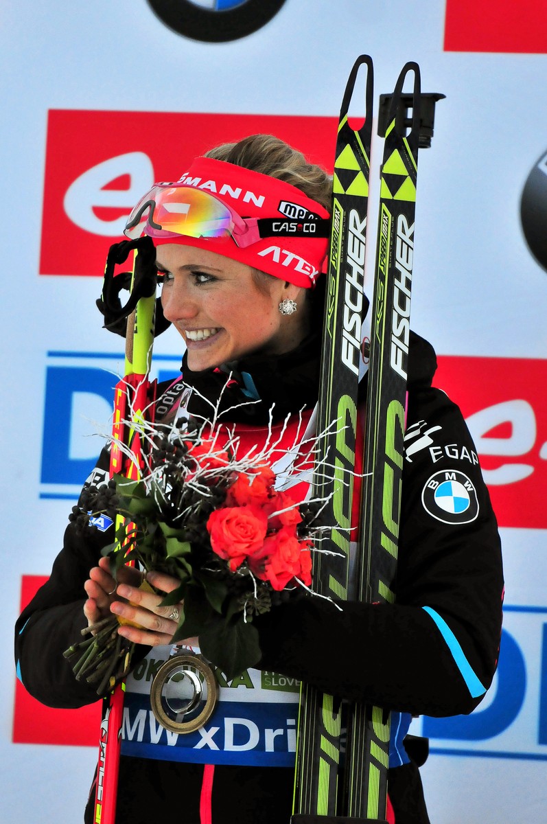 epa04533802 Gabriela Soukalova from the Czech Republic smiles on the podium after winning the women's 7.5km Sprint race of the Biathlon World Cup in Pokljuka, Slovenia, 18 December 2014. EPA/IGOR KUPLJENIK