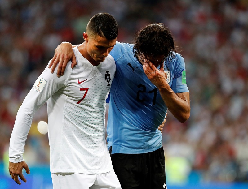 epaselect epa06853381 Portugal's Cristiano Ronaldo (L) helps Uruguay's Edinson Cavani during the FIFA World Cup 2018 round of 16 soccer match between Uruguay and Portugal in Sochi, Russia, 30 June 2018. (RESTRICTIONS APPLY: Editorial Use Only, not used in association with any commercial entity - Images must not be used in any form of alert service or push service of any kind including via mobile alert services, downloads to mobile devices or MMS messaging - Images must appear as still images and must not emulate match action video footage - No alteration is made to, and no text or image is superimposed over, any published image which: (a) intentionally obscures or removes a sponsor identification image; or (b) adds or overlays the commercial identification of any third party which is not officially associated with the FIFA World Cup) EPA-EFE/JUAN HERRERO EDITORIAL USE ONLY EDITORIAL USE ONLY