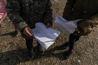 Unii dintre copiii evacuați ne arată fișele pe care le-au completat pentru școala online.