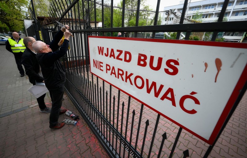 City officials put up a warning sign on the gate of a former Russian high school in Warsaw, Poland on April 29, 2023. Poland on April 29, 2023 said it had seized the high school building near Moscow's embassy in Warsaw meant for the children of diplomats, a move the Russian envoy called "illegal".,Image: 772769721, License: Rights-managed, Restrictions: , Model Release: no