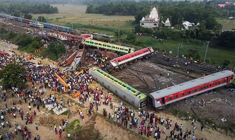 This screen grab made from AFPTV video footage taken on June 3, 2023 shows people gathering at the accident site of a three-train collision near Balasore, about 200 km (125 miles) from the state capital Bhubaneswar in the eastern state of Odisha. At least 288 people were killed and more than 850 injured in a horrific three-train collision in India, officials said on June 3, the country's deadliest rail accident in more than 20 years.,Image: 781120659, License: Rights-managed, Restrictions: , Model Release: no