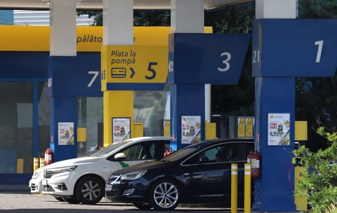 Două mașini așteptând să alimenteze la benzinărie