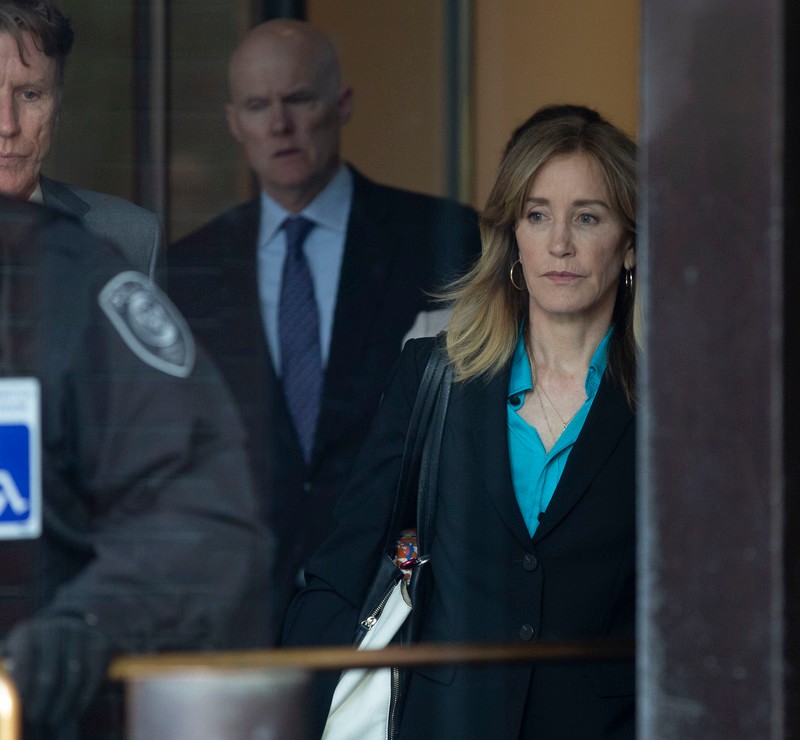 epa07483342 US actress Felicity Huffman (R) leaves the John J Moakley Federal Court House after facing charges in a nationwide college admissions cheating scheme in Boston, Massachusetts, USA 03 April 2019. EPA-EFE/CJ GUNTHER
