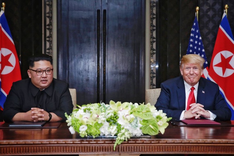 epa06801600 US President Donald J. Trump (R) looks on as North Korean Chairmain Kim Jong-un (L) speaks during a document signing ceremony during their historic DPRK-US summit, at the Capella Hotel on Sentosa Island, Singapore, 12 June 2018. The summit marks the first meeting between an incumbent US President and a North Korean leader. EPA-EFE/KEVIN LIM / THE STRAITS TIMES / SPH EDITORIAL USE ONLY EDITORIAL USE ONLY