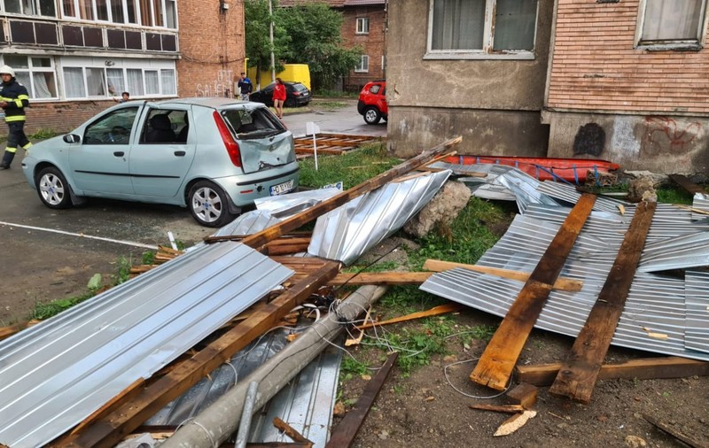 Bloc decopertat, mașini avariate și un stâlp de curent pus la pământ în Valea Jiului, după o furtună puternică