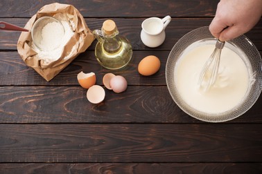 dough and products for its preparation on dark wooden background