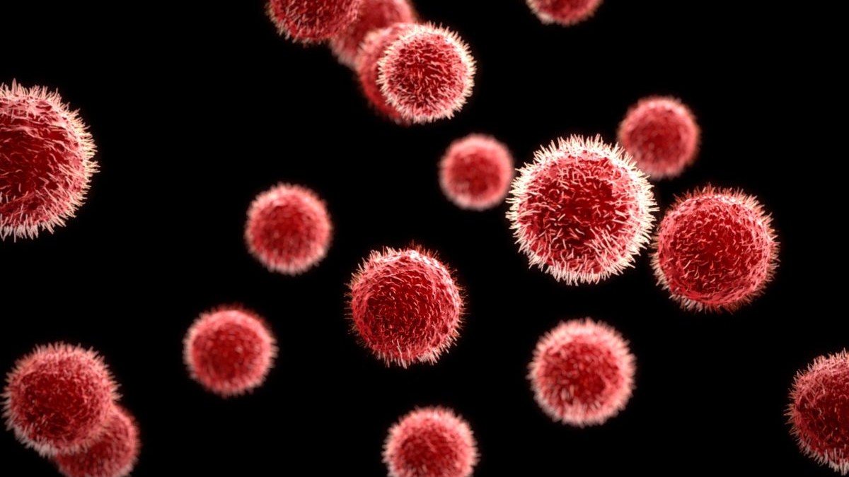 Imagine creativă cu un virus privit prin microscop, sub forma unor sfere de culoare roșie pe fundal negru