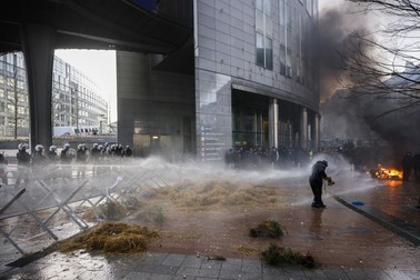 Anti riot police use water to disperse people during a protest by farmers outside the European Parliament as European leaders meet for an EU summit in Brussels, Thursday, Feb. 1, 2024. European Union leaders meet in Brussels for a one day summit to discuss the revision of the Multiannual Financial Framework 2021-2027, including support for Ukraine.,Image: 842366300, License: Rights-managed, Restrictions: This content is intended for editorial use only. For other uses, additional clearances may be required., Model Release: no