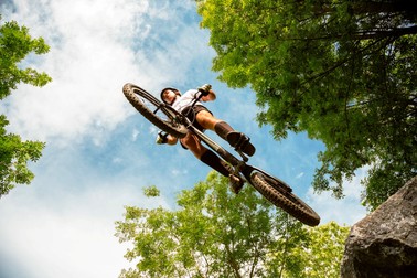 Cyclist extreme jumping from a rock