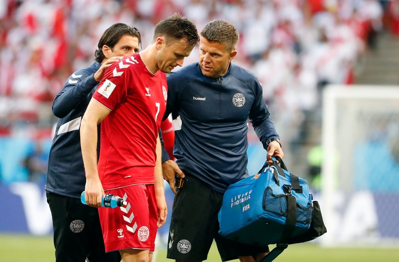 epa06813894 William Kvist of Denmark (C) gets medical assistance during the FIFA World Cup 2018 group C preliminary round soccer match between Peru and Denmark in Saransk, Russia, 16 June 2018. (RESTRICTIONS APPLY: Editorial Use Only, not used in association with any commercial entity - Images must not be used in any form of alert service or push service of any kind including via mobile alert services, downloads to mobile devices or MMS messaging - Images must appear as still images and must not emulate match action video footage - No alteration is made to, and no text or image is superimposed over, any published image which: (a) intentionally obscures or removes a sponsor identification image; or (b) adds or overlays the commercial identification of any third party which is not officially associated with the FIFA World Cup) EPA-EFE/ERIK S. LESSER EDITORIAL USE ONLY EPA-EFE/ERIK S. LESSER EDITORIAL USE ONLY EDITORIAL USE ONLY EPA-EFE/ERIK S. LESSER EDITORIAL USE ONLY EDITORIAL USE ONLY
