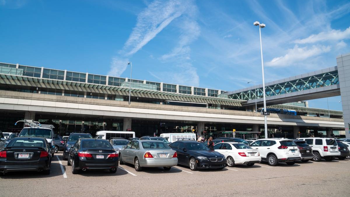 Mai multe masini în parcarea de la Aeroportul Internațional Logan din Boston, SUA, intr-o zi însorita cu cer senin. 2019