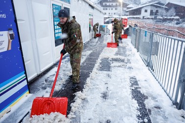 Italian military personnel shovel snow to clear the entrance outside the Olympic Stadium on the way to the media centre during the Milano Cortina 2026 Winter Olympic Games in Cortina d'Ampezzo on February 4, 2026.,Image: 1072055466, License: Rights-managed, Restrictions: , Model Release: no