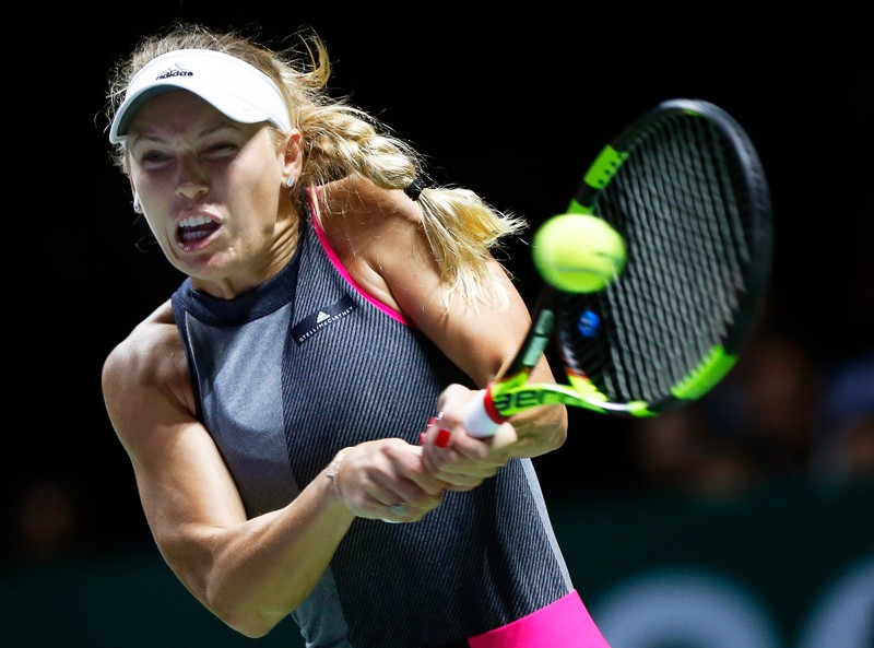epa06292420 Caroline Wozniacki of Denmark in action against Caroline Garcia of France during their round robin match of the BNP Paribas WTA Tour Finals 2017 tennis tournament at the Indoor Stadium in Singapore, 27 October 2017. EPA-EFE/WALLACE WOON